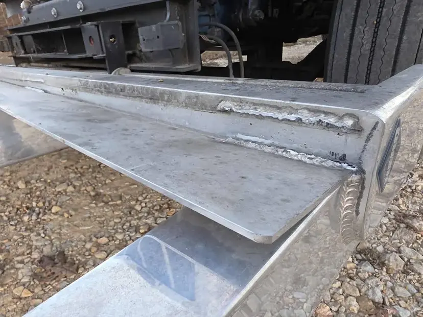 Close view of a welded metal step on a work truck